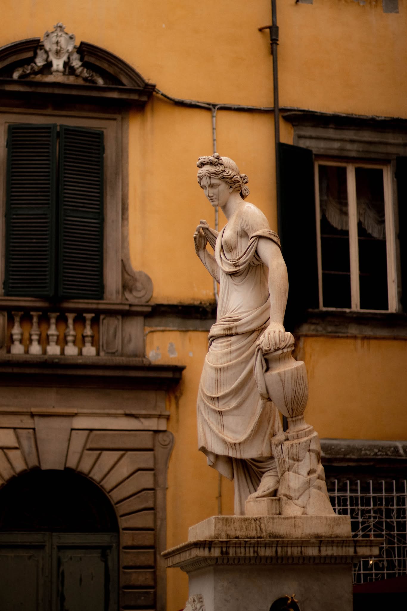 Picturesque street in Lucca. Fontana della Pupporona in Lucca.